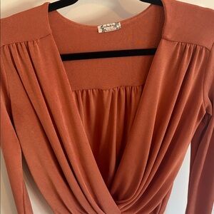 Free People Turnt body suit in colour “mesa”.